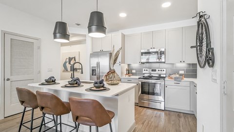 A modern kitchen with a dining table and chairs.