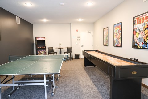 Game room with ping pong and shuffleboard tables at Rivers Edge Apartments, Otsego, 55330
