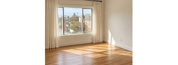 A room with a large window overlooking a cityscape.