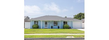 A blue house with a white garage door.
