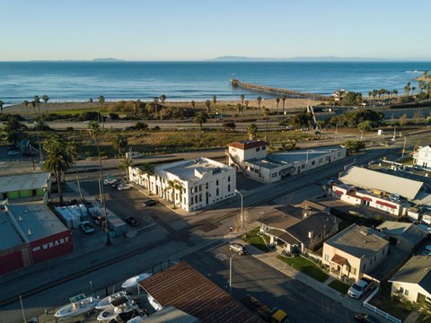 A view of a beachfront area with a pier extending into the water.