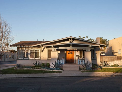 A house with a brown door and a small front yard.