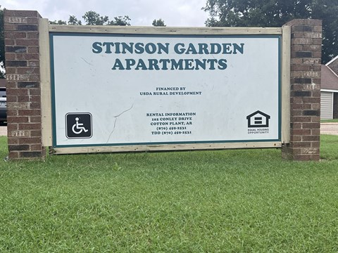 a sign apartments with a wheelchair accessible sign on it