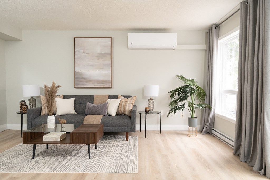 a living room with a gray couch and a brown coffee table