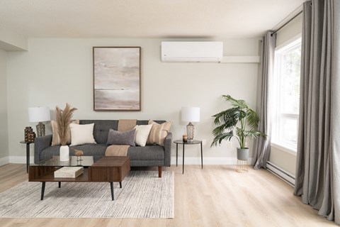 a living room with a gray couch and a brown coffee table