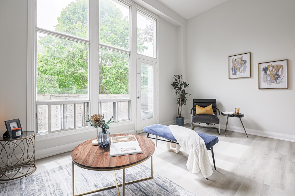 A living room with a blue chair and a coffee table.