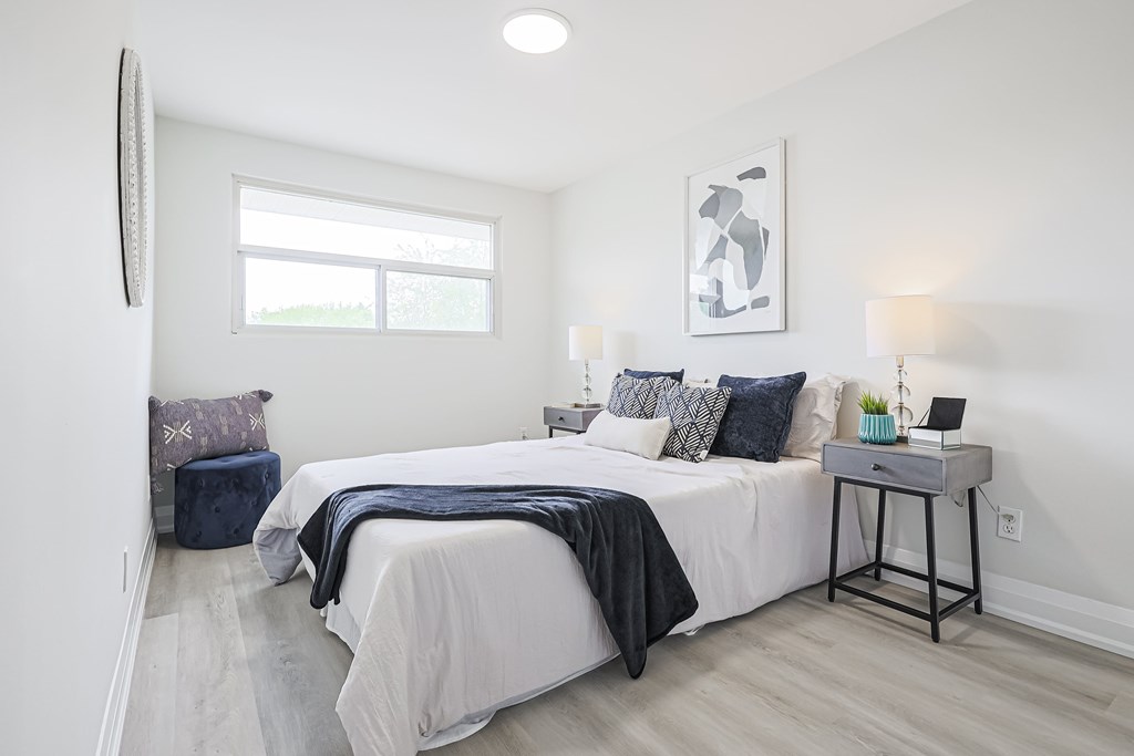 A bedroom with a large bed and a window.