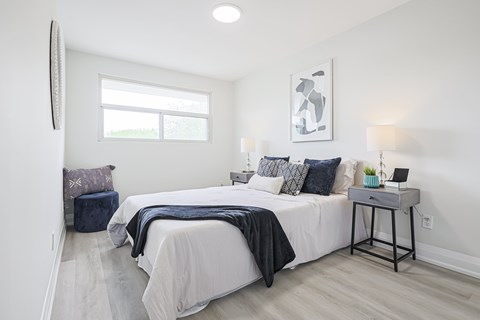 A bedroom with a large bed and a window.