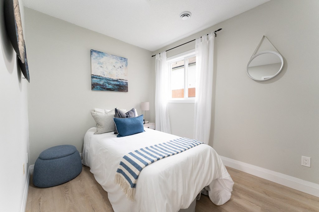 a bedroom with a bed and a chair in a 555 waverly unit