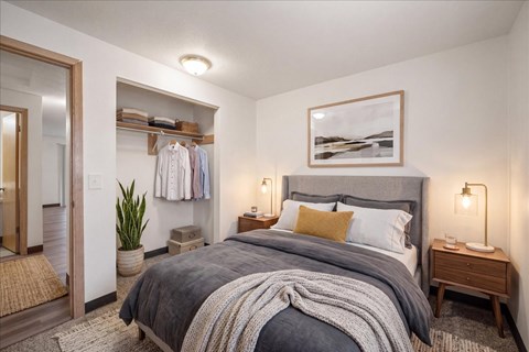 A bedroom with a large bed and a mirror on the wall.