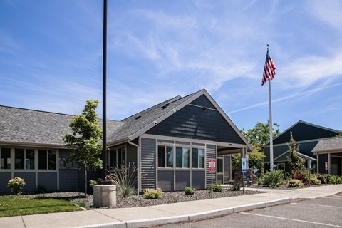 A grey building with a flag on top of it.