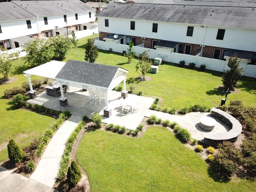 an aerial view of a backyard with a picnic area and a pavilion