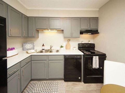 a kitchen with black appliances and gray cabinets
