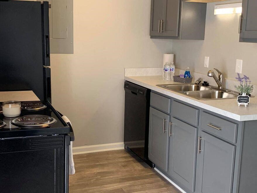 a small kitchen with a stove sink and refrigerator