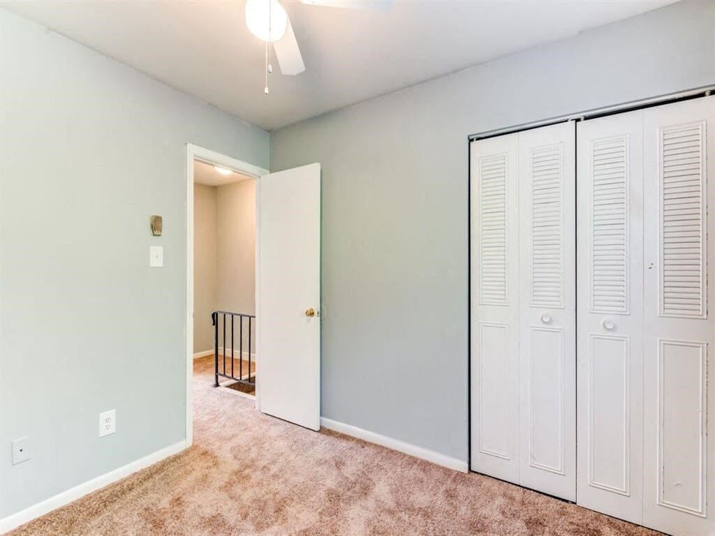 a bedroom with a closet and a door to a hallway