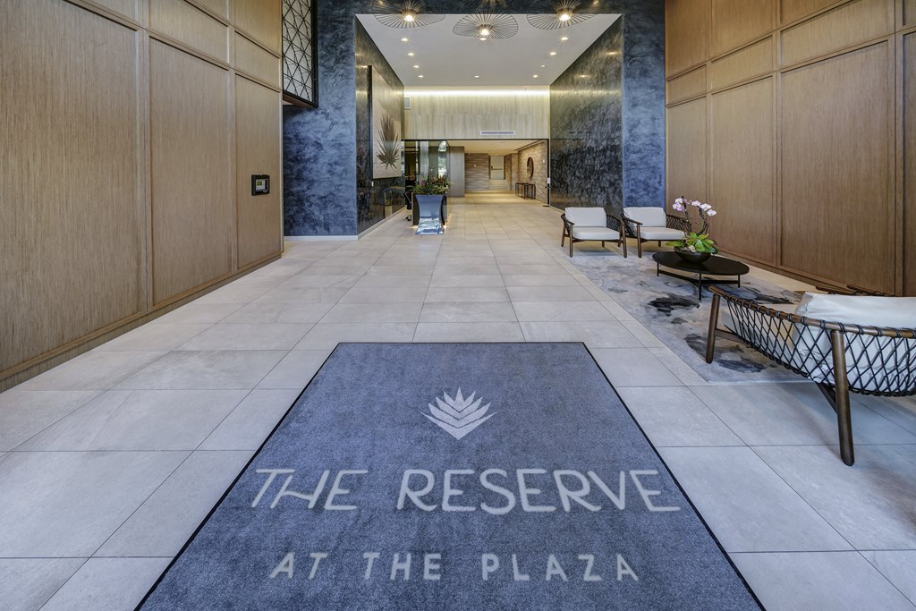 a rug that reads the reserve at the plaza in the lobby of a building