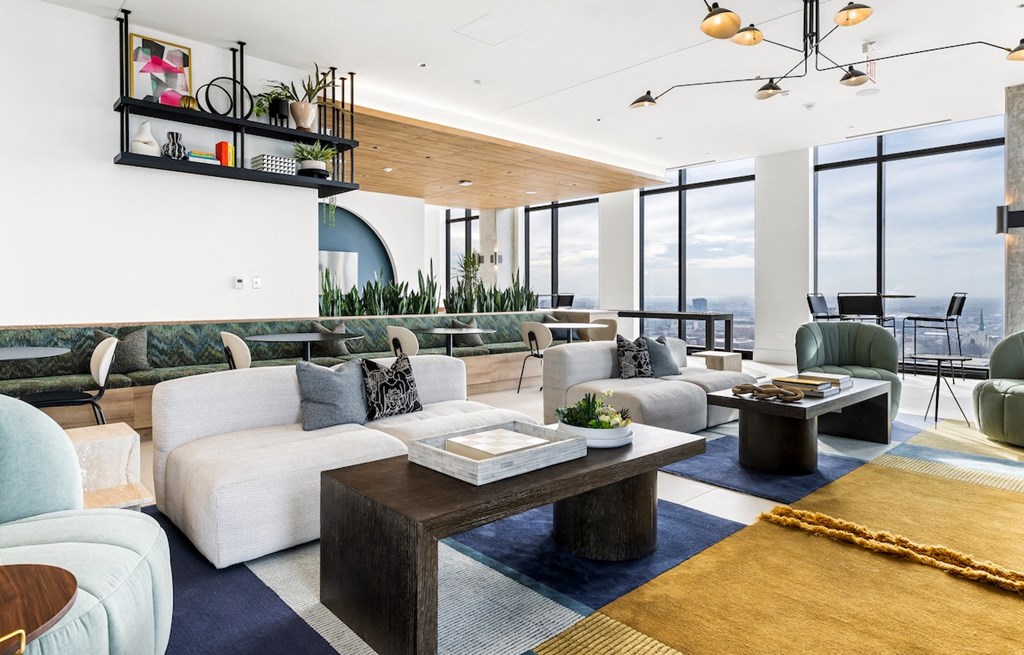 a living room with white couches and a coffee table