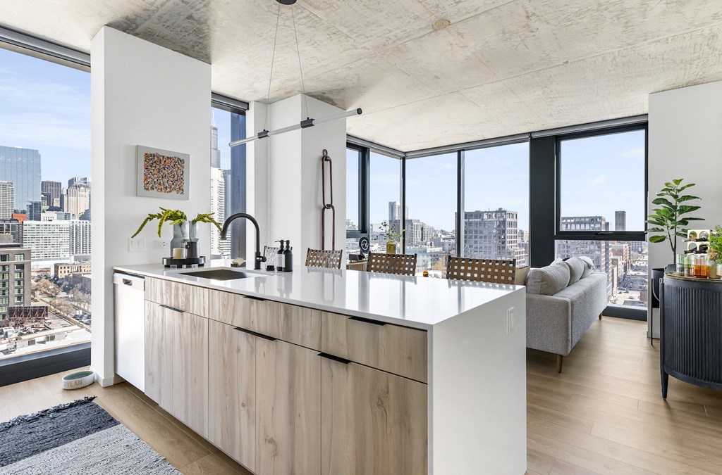 a kitchen with a large island and a view of the city