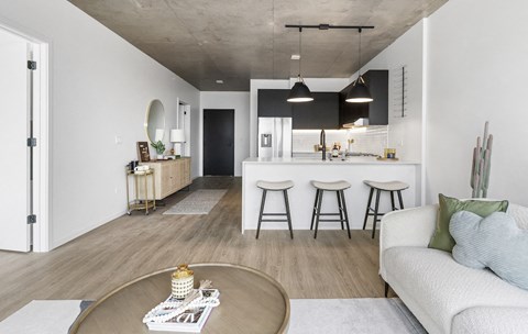 A modern living room with a white couch and a coffee table.
