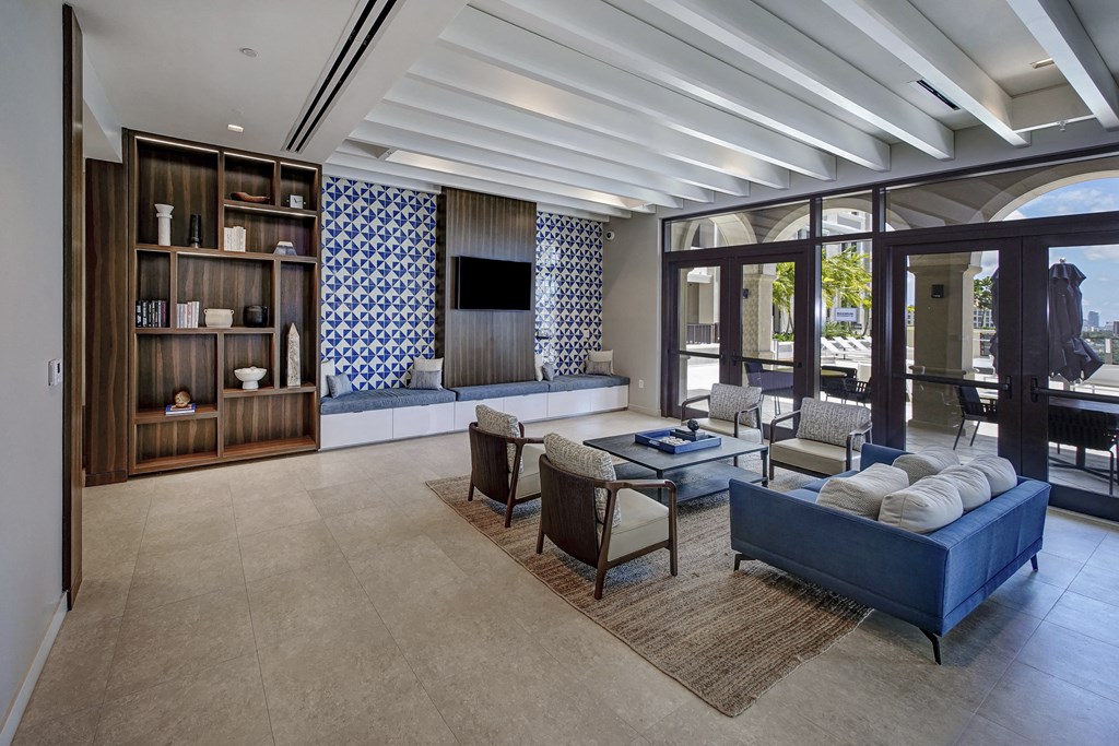 a living room with couches and chairs and a television