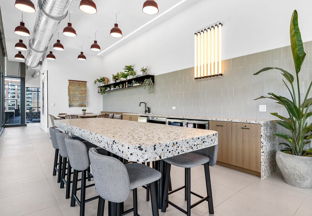 a long kitchen with a long table and chairs