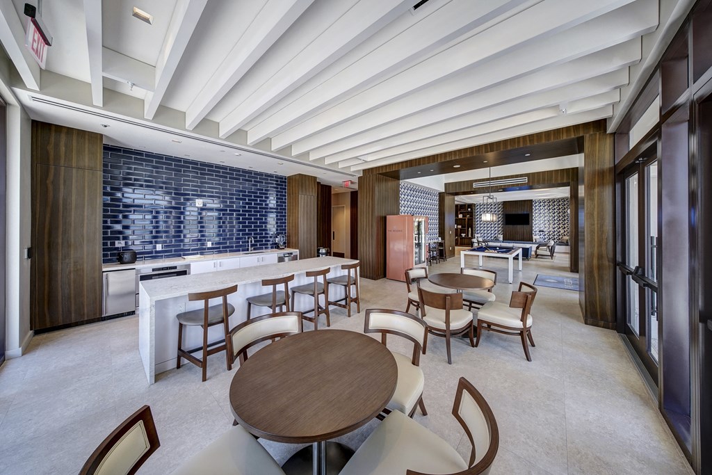 a dining room with tables and chairs and a bar