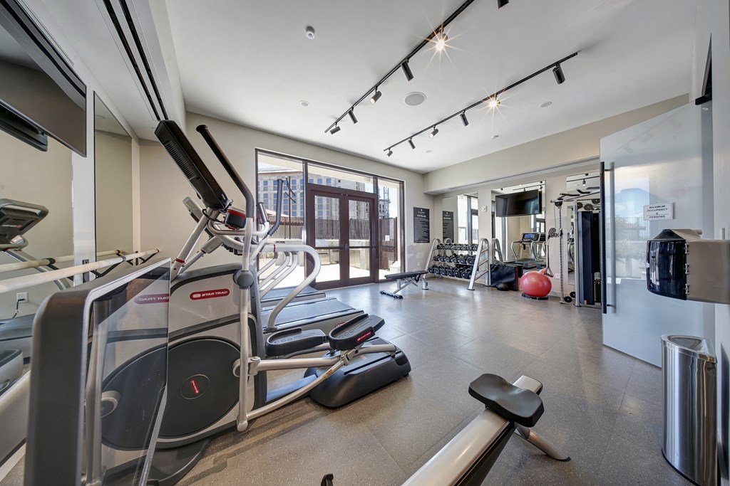 a gym with treadmills and other exercise equipment at the flats at west end