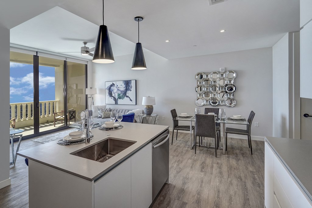 a kitchen and dining room with a view of the ocean in a new home