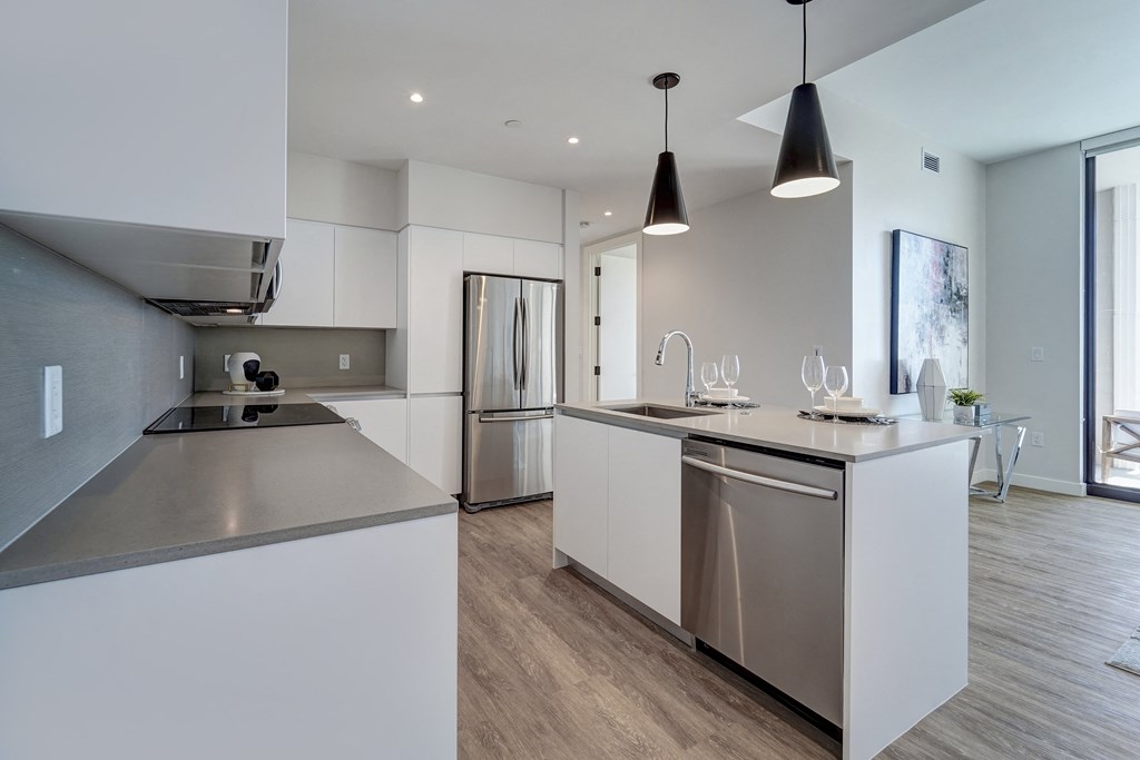 a kitchen with an island and stainless steel appliances in a house