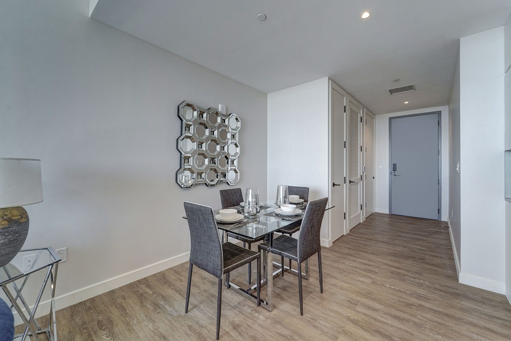 a dining room with a glass table and chairs