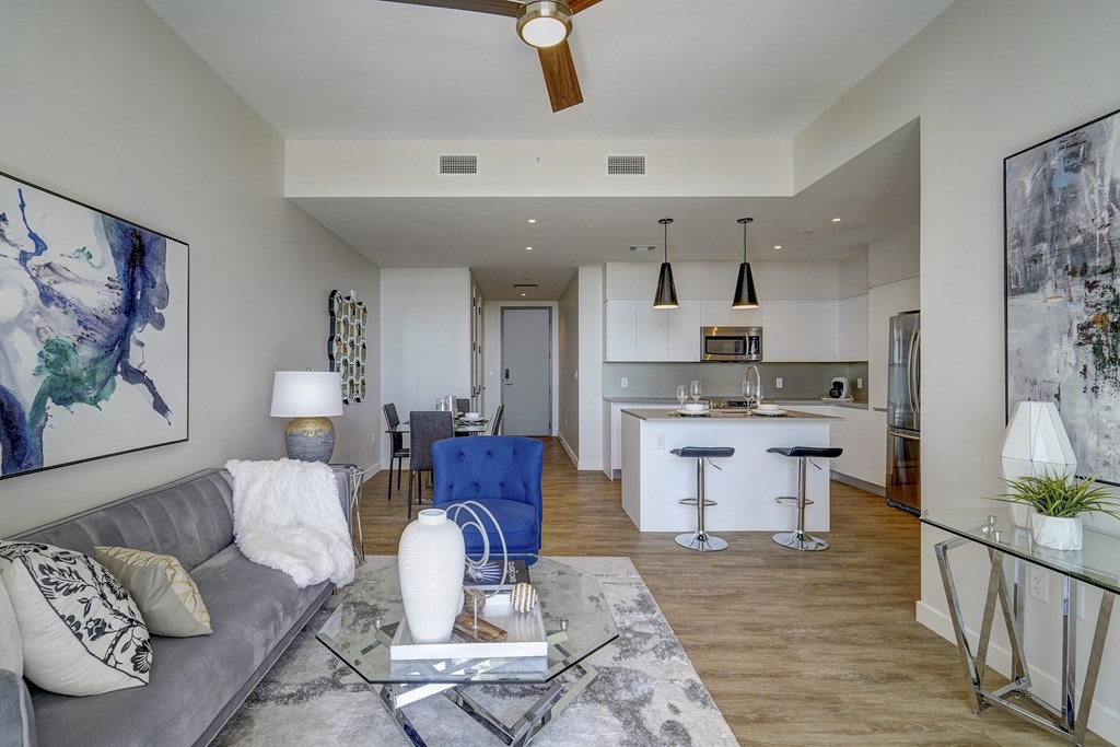a living room and kitchen with a couch and a table