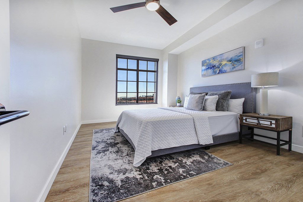 a bedroom with a bed and a ceiling fan