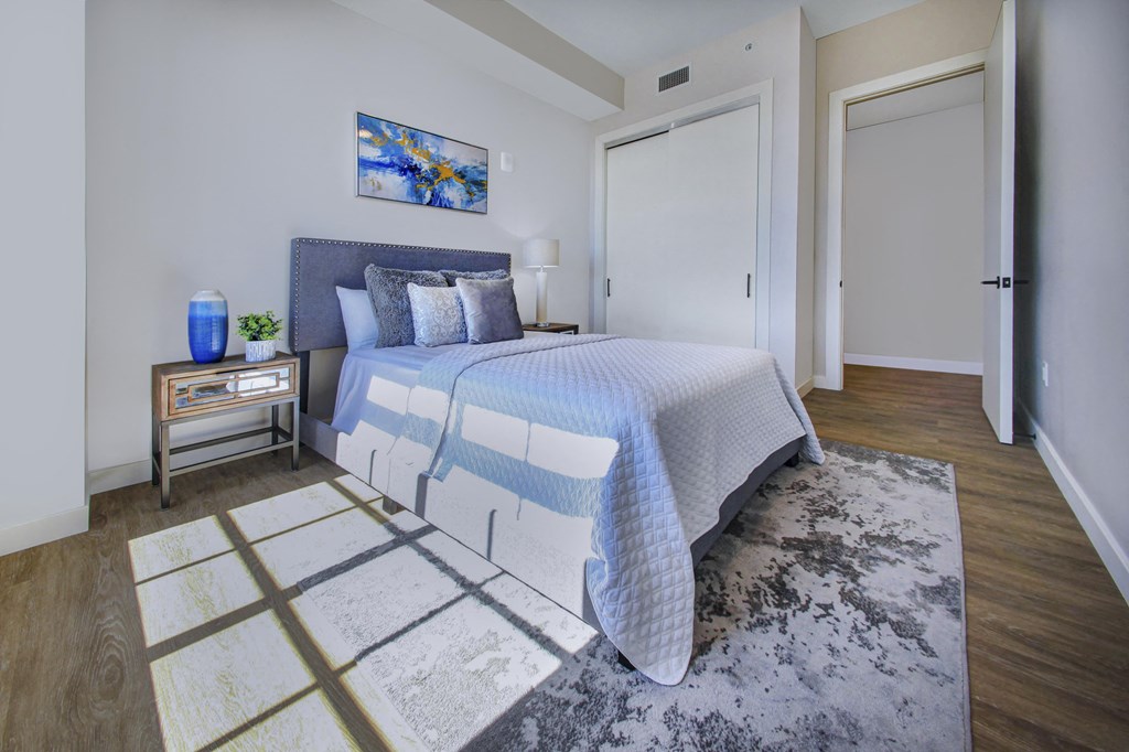 a bedroom with a large bed and a door to a bathroom