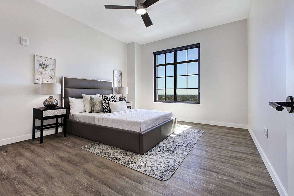 a bedroom with a bed and a window