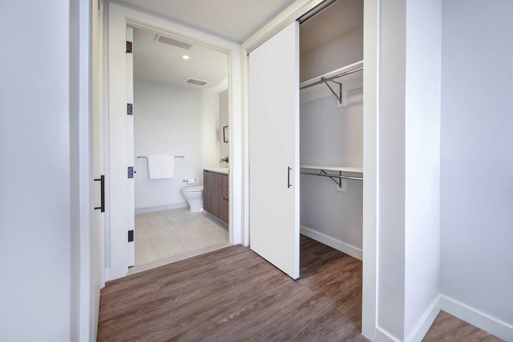 a bathroom with a door to a closet and a toilet