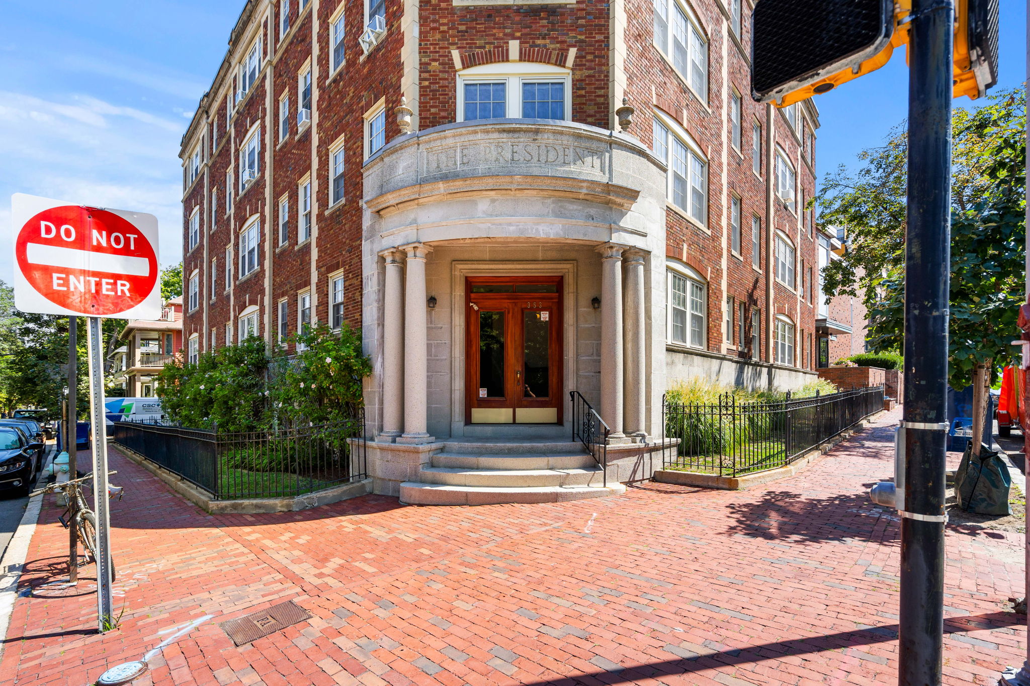 A red brick building with a "Do Not Enter" sign in front.