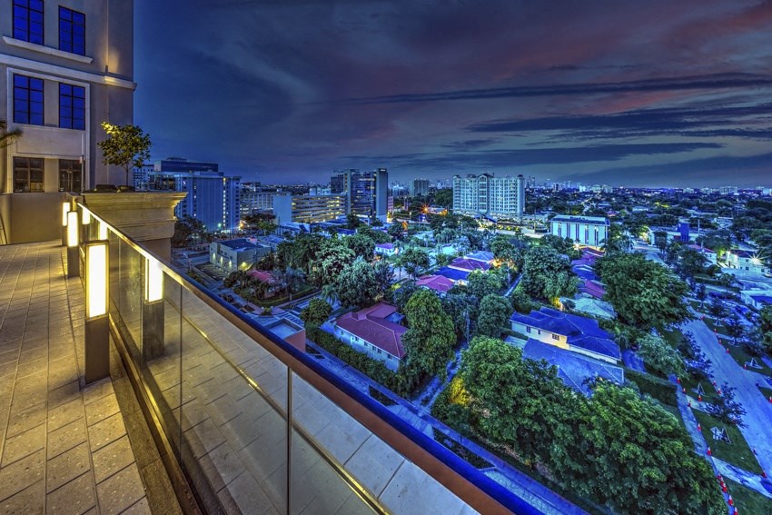 a view of a city from a balcony at night