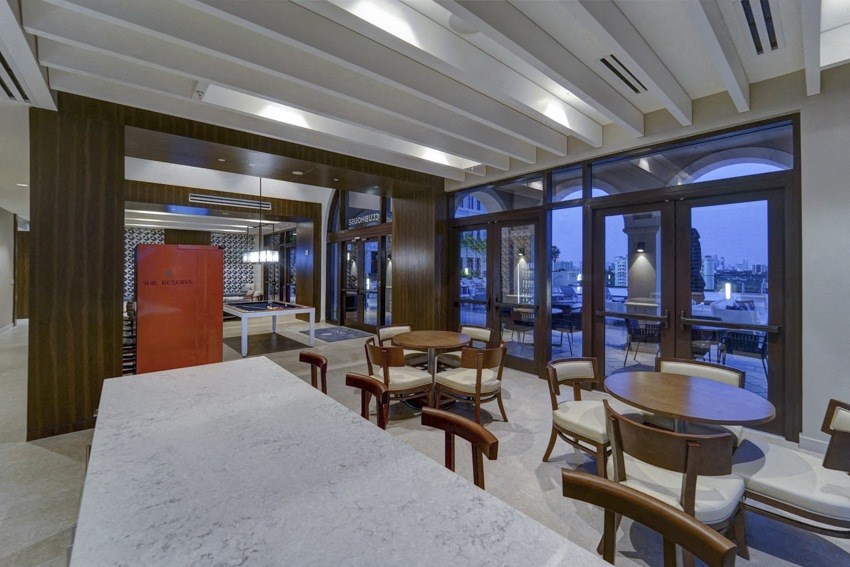 a restaurant with tables and chairs and large windows