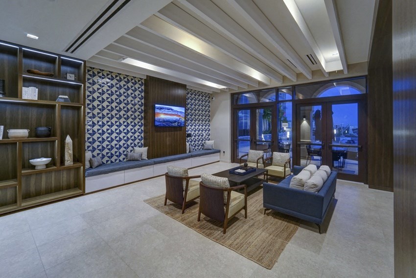 a living room with a couch and chairs and a large window