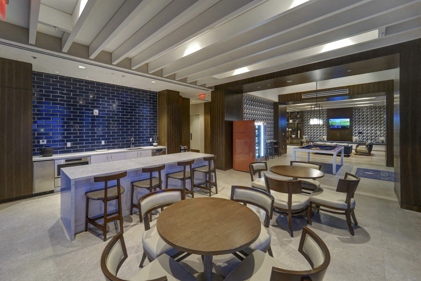 the lobby of a restaurant with tables and chairs