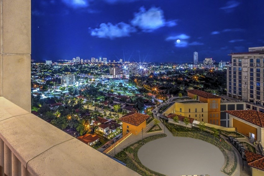 a view of a city at night from a balcony