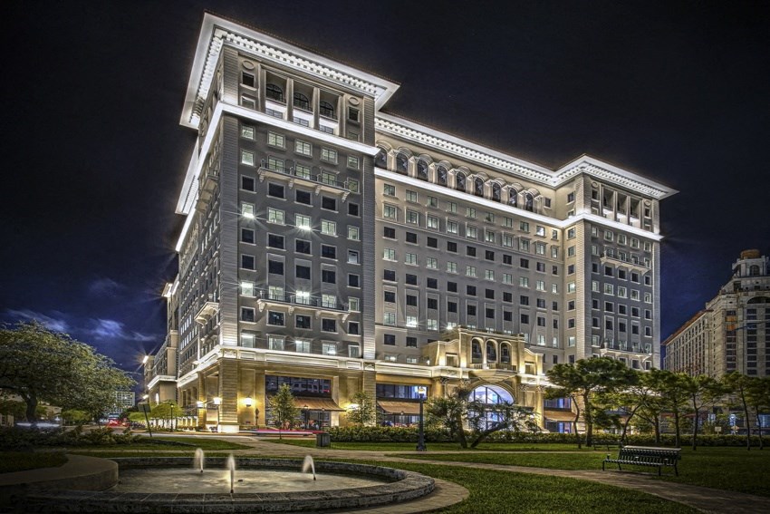 a large building at night with a fountain
