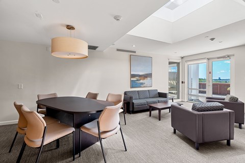 A modern dining room with a large table and chairs.