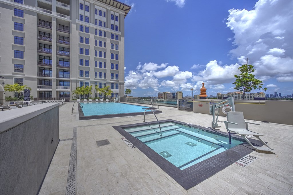 a swimming pool and spa on the rooftop of a building
