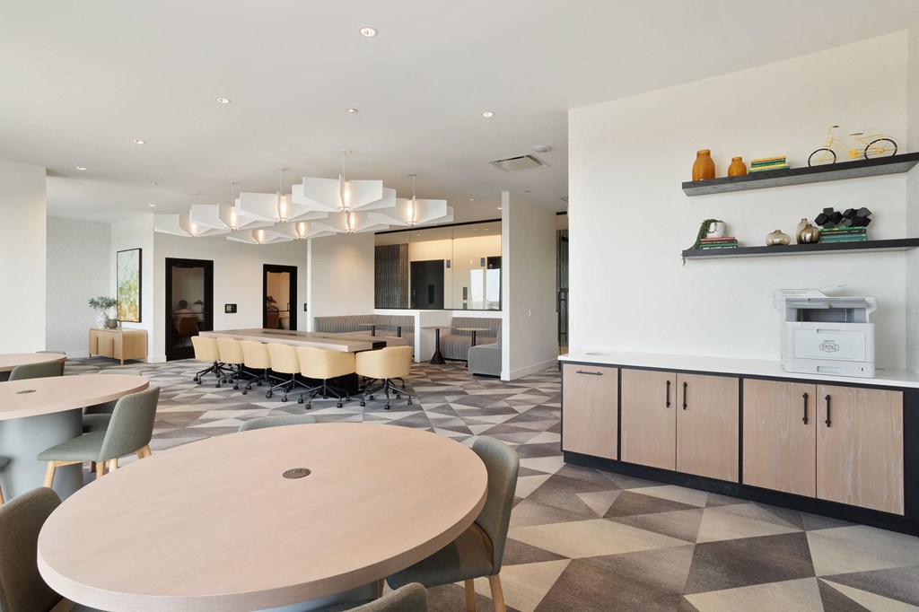 a communal area with tables and chairs and a kitchenette at Platform 4611, Chicago, 60640