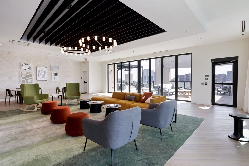 a living room filled with furniture and a large window at Platform 4611, Chicago, 60640