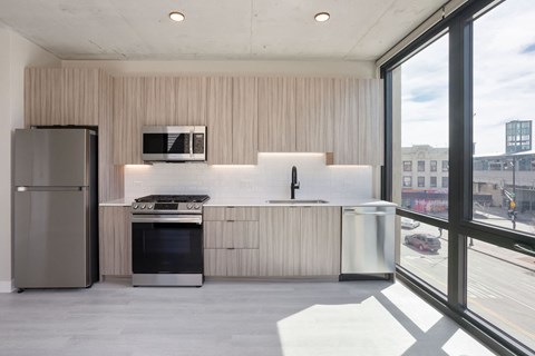 a kitchen with a refrigerator freezer and a stove top oven