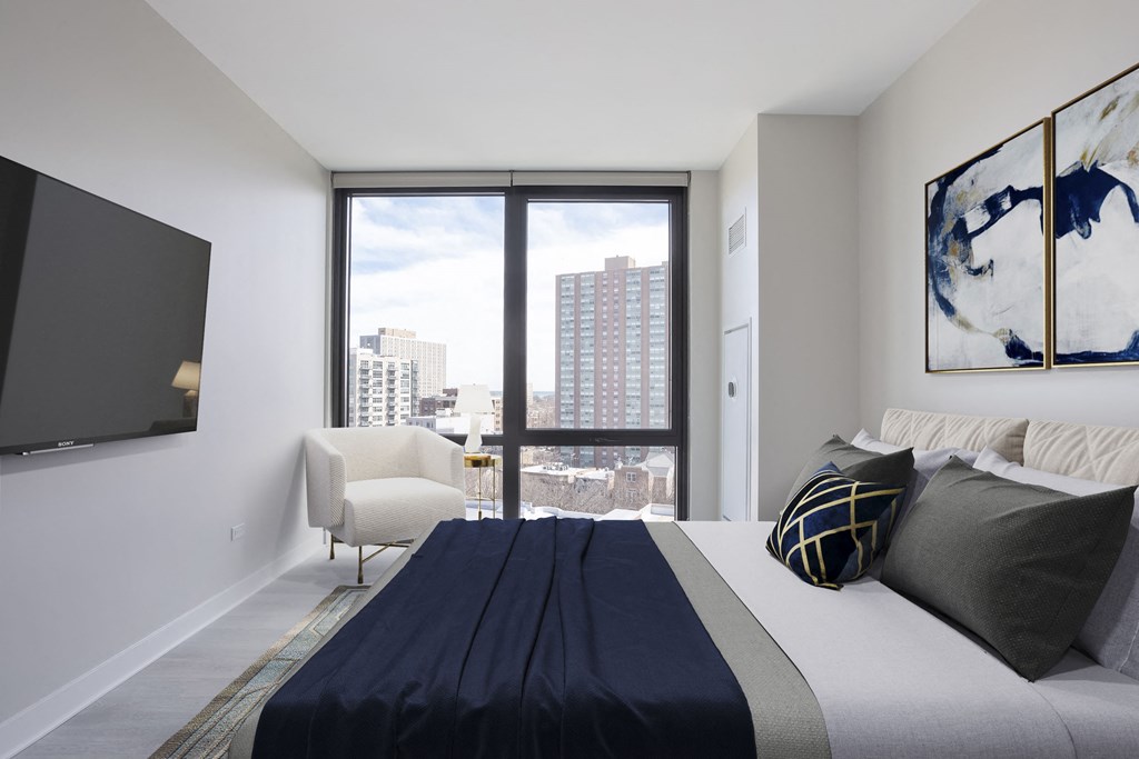 a bedroom with a large bed and a large window  at Platform 4611, Chicago, IL 60640