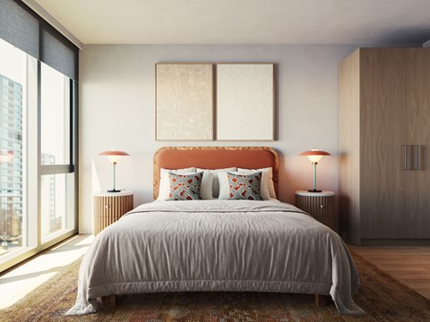 A bedroom with a large bed and two lamps.