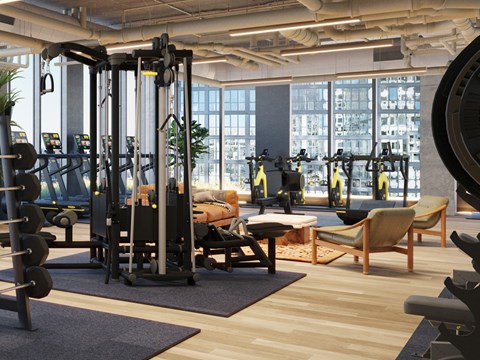 A gym with a variety of equipment including weights and machines.
